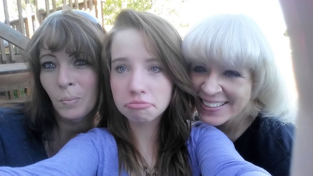 Three women are posing for a picture together.