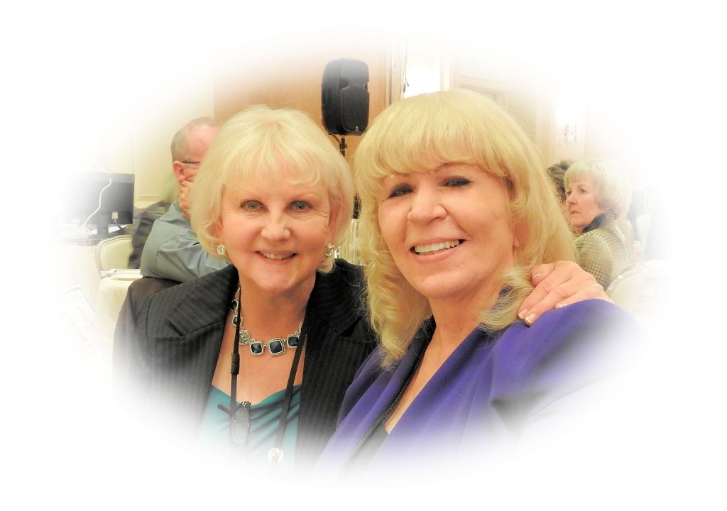 Two women posing for a picture in front of a microphone.