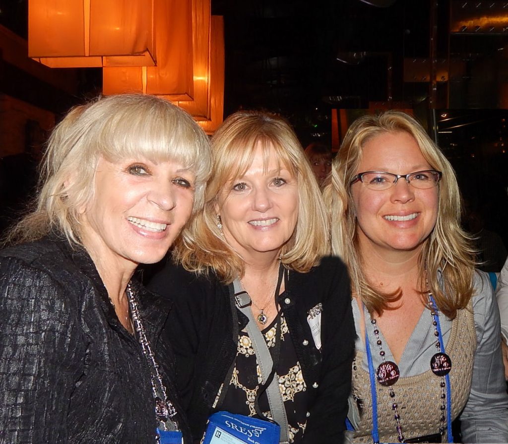 Three women are posing for a picture together.