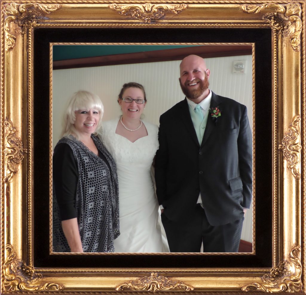 A picture of the bride and groom with their parents.