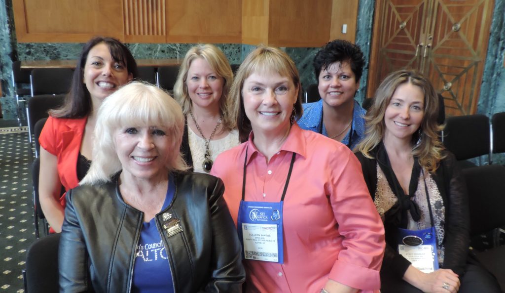 A group of women standing next to each other.